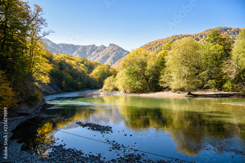 Landscape with mountain river and forest in autumn