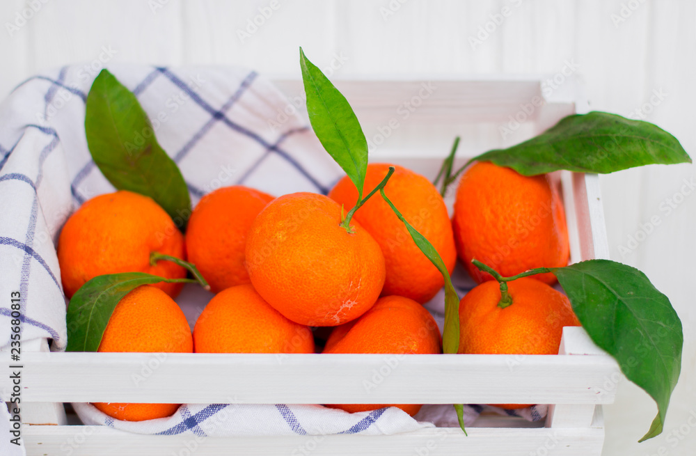 Tangerines in a white small box