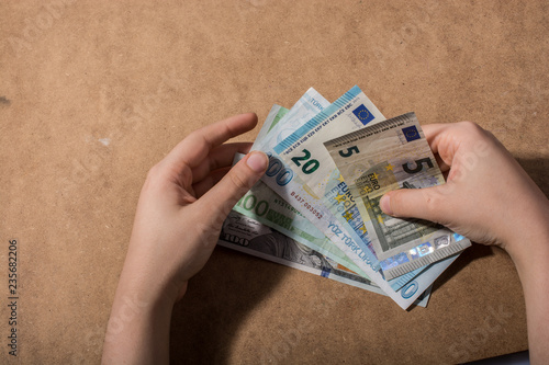 Hand holding American dollar  isolated on wooden background photo