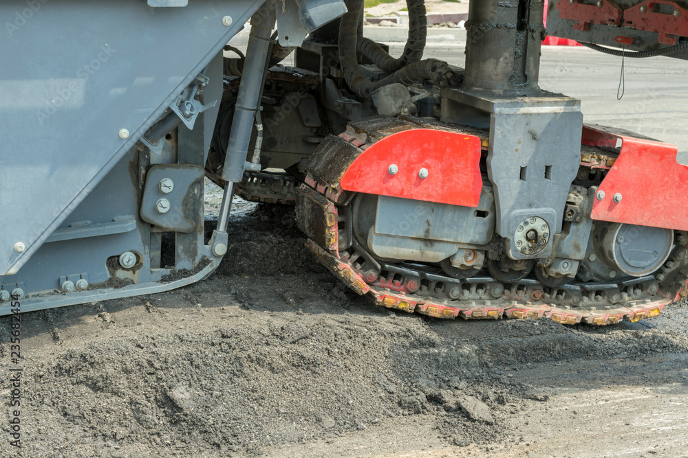 Machinery for asphalting roads. Close view on the workers and the asphalting machines. Machinery for asphalting roads Machinery for asphalting roads. Close view on the workers and the asphalting machines. Machinery for asphalting roads