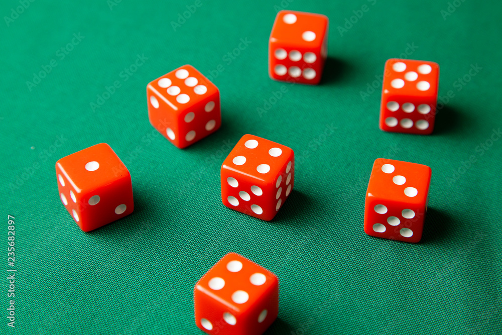 Red dices on green poker gaming table in casino. Concept online gambling Red dices on green poker gaming table in casino. Concept online gambling