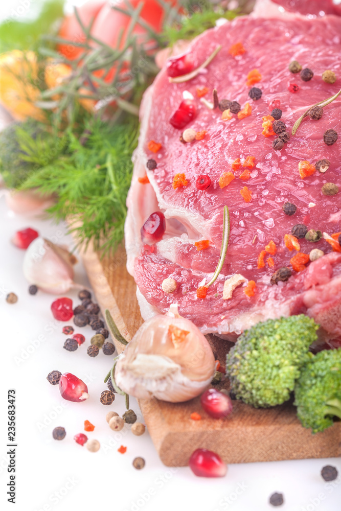 .fresh beef steak with vegetables on a white background