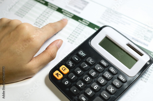 Close up woman using calculator with space for you design, selective focus.