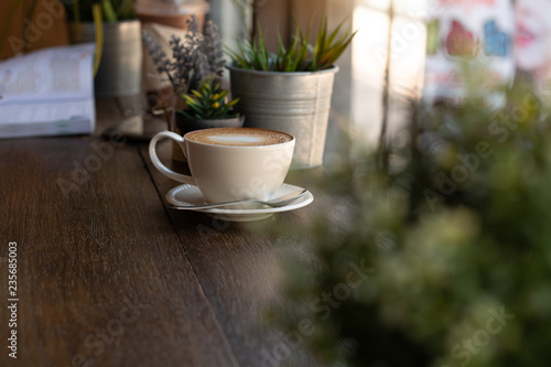 Coffee cup is located in a coffee shop