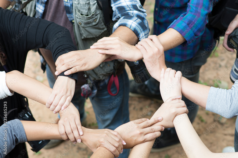 Fototapeta premium The hands of young people who unite together.