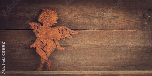 metal angel on wooden board