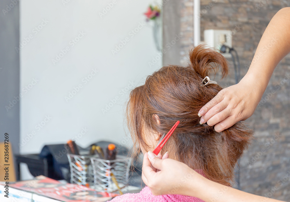 Fototapeta premium Close up of Women's haircut at the hair salon blurred background