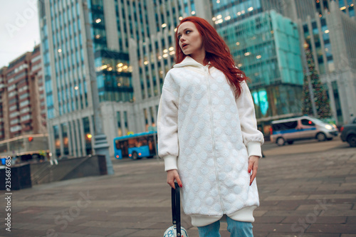 Young stylish woman walking street