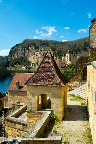 Picturesque honeypot village of La Roque-Gageac is built under the cliffs beside the Dordogne River in Dordogne, Nouvelle Aquitaine, France.  photo