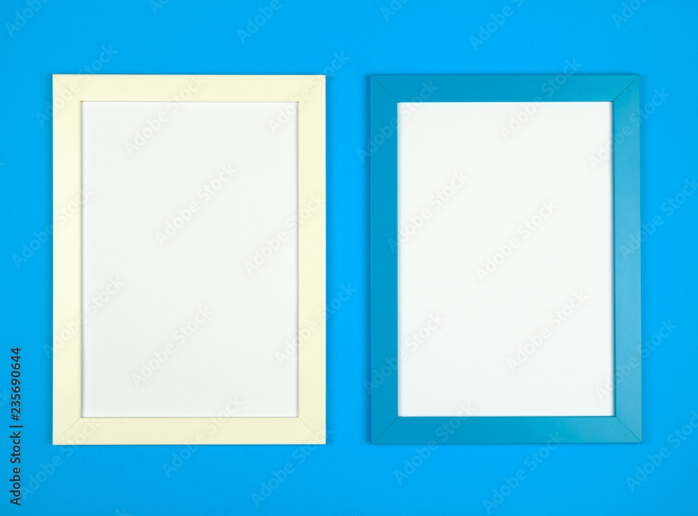 Flat lay pastel colored background with empty picture frame