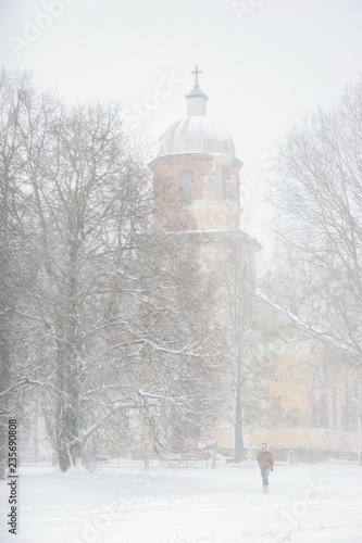 Winter landscape with snow covered church and trees. photo