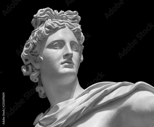 Portrait of a plaster statue of Apollo isolated on black photo