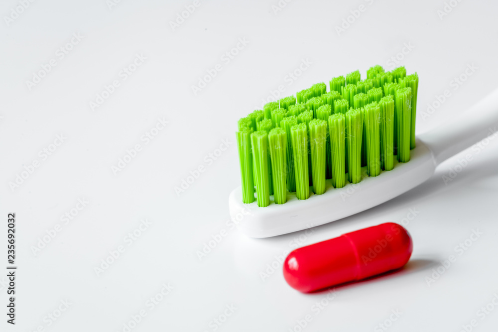 concept toothache with toothbrush and pills at white background concept toothache with toothbrush and pills at white background