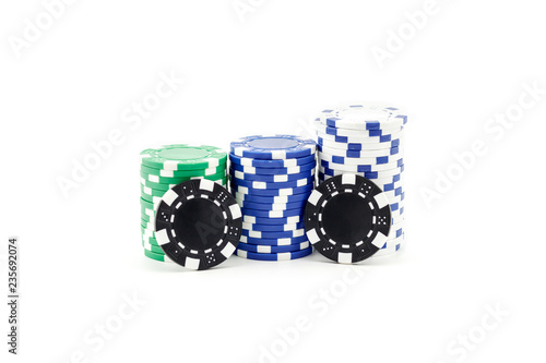 Casino games concept,Stacks of poker chipson gamble table including red, black, white, green and blue on a white background. photo