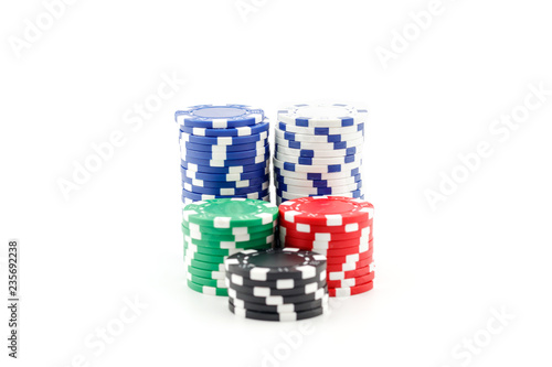 Casino games concept,Stacks of poker chipson gamble table including red, black, white, green and blue on a white background. photo