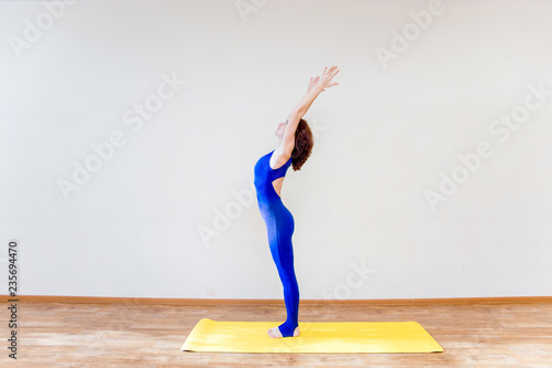 a woman practicing yoga exercises at home