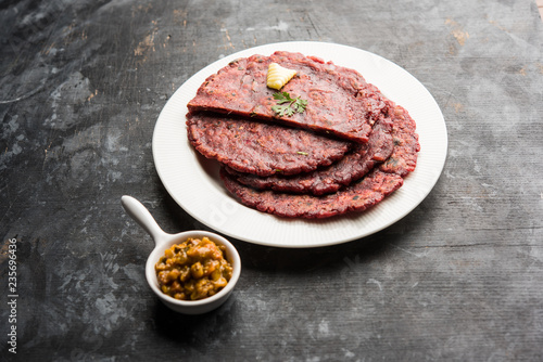 Ragi Roti made from finger millet from India is extremely rich in proteins served with pickle or achar. selective focus photo