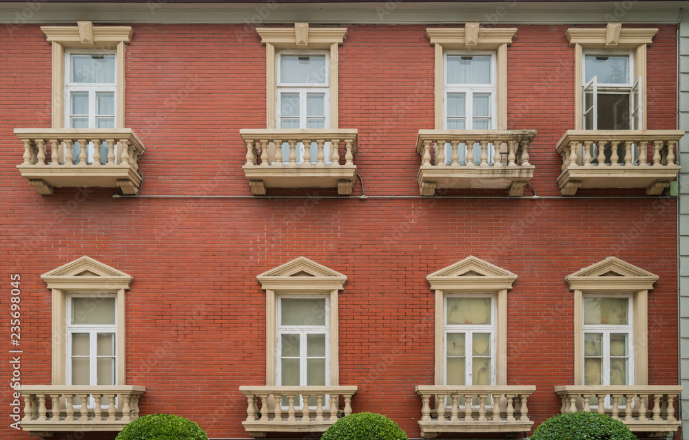 The facade of the old house. The Windows and decoration of walls The facade of the old house. The Windows and decoration of walls