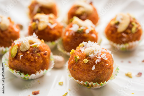 Carrot Halwa Laddu or sweet balls, served in a plate with dry fruits toppings. selective focus