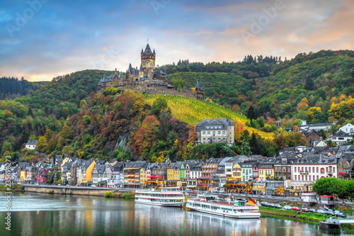Cochem in autumn, Germany. Cityscape with Moselle river, colorful houses on embankment and Cochem Castle photo