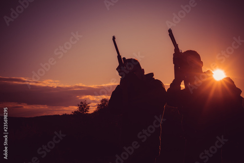Silhouette of the hunter. Hunting Equipment for sale. Rifle Hunter Silhouetted in Beautiful Sunset. Copy space for text.