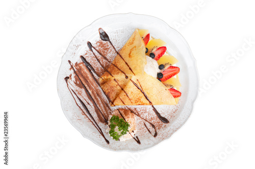 Top view of Cold crepe with vanilla ice cream, strawberry, kiwi and whipped cream topped with chocolate sauce isolated on white background (with clipping path).