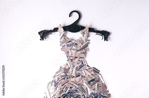 A dress made of metafan on a black coat hanger. photo