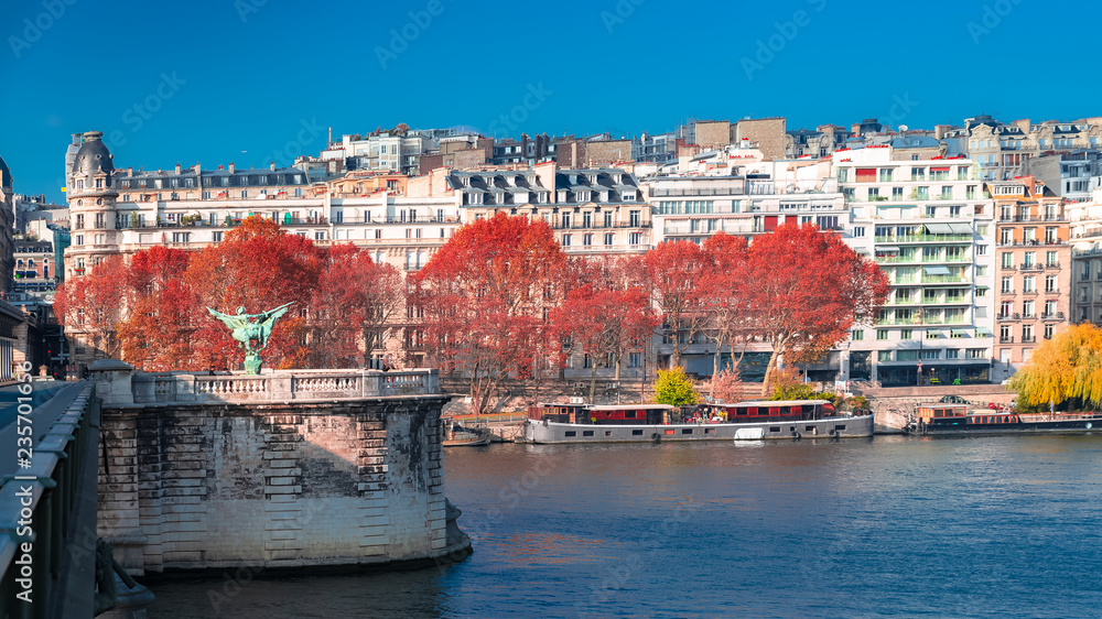 Paris, panorama of the Seine in backlight in autumn, the Bir-Hakeim bridge and beautiful parisian buildings
