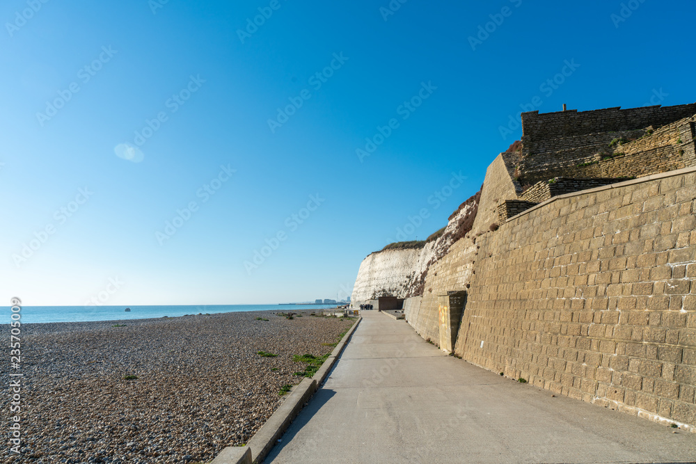 Saltdean beach seafront and white sandstone chalk cliffs with walkway for people exercise. Undercliff walkway at East Sussex Brighton marina, UK.