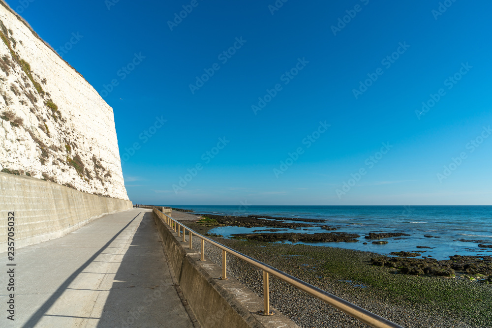 Saltdean beach seafront and white sandstone chalk cliffs with walkway for people exercise. Undercliff walkway at East Sussex Brighton marina, UK.