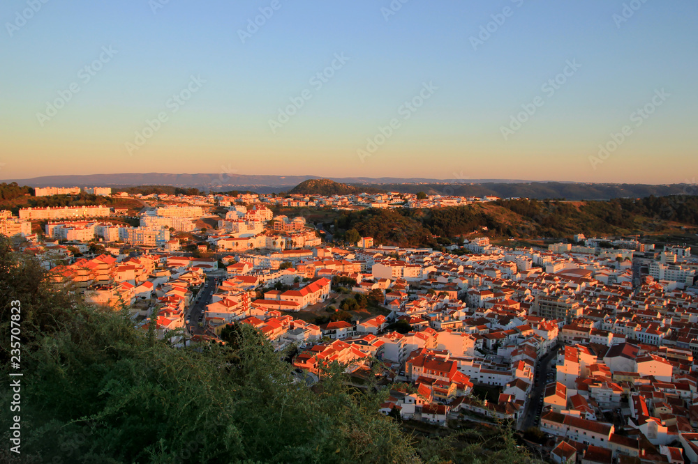 Pretty town Nazare at sunset, Portugal