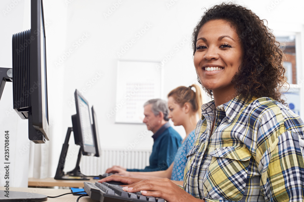 Portrait Of Young Woman Attending Computer Class In Front Of Screen