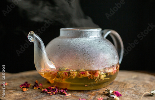 Close up of rose petal and vanilla tea in teapot