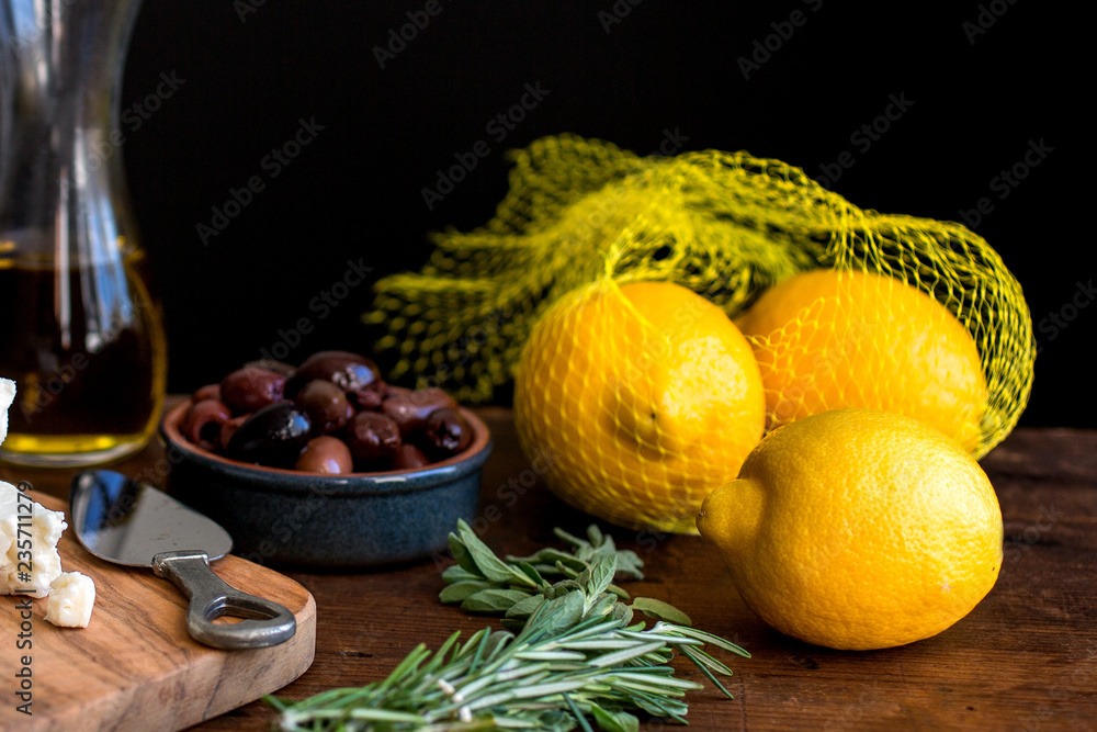 Close up of olives, lemon, feta, on wooden table Close up of olives, lemon, feta, on wooden table