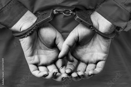 the girl's hand in handcuffs to detain criminals behind his back. arrest, breaking the law.
