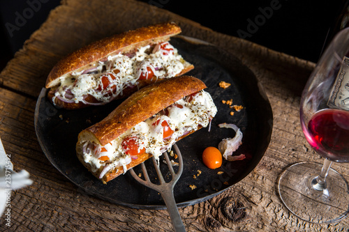 Close up of pissaladierre baguette served on plate  photo