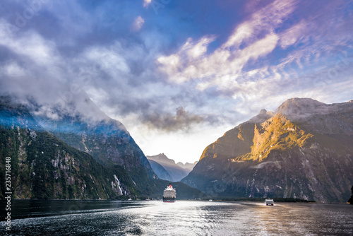 Beautiful scenic Mountain and Fjord landscape at Milford Sound with a Cruise ship. Fiordland National Park, New Zealand.