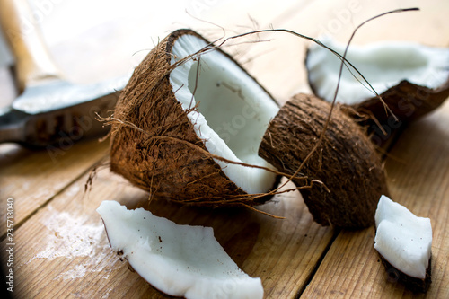 Close up of broken coconut on wooden table