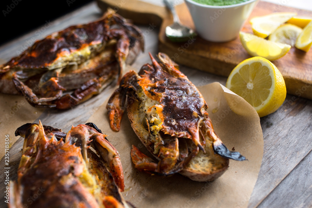 Close up of soft shell crab toasts served on wooden table Close up of soft shell crab toasts served on wooden table