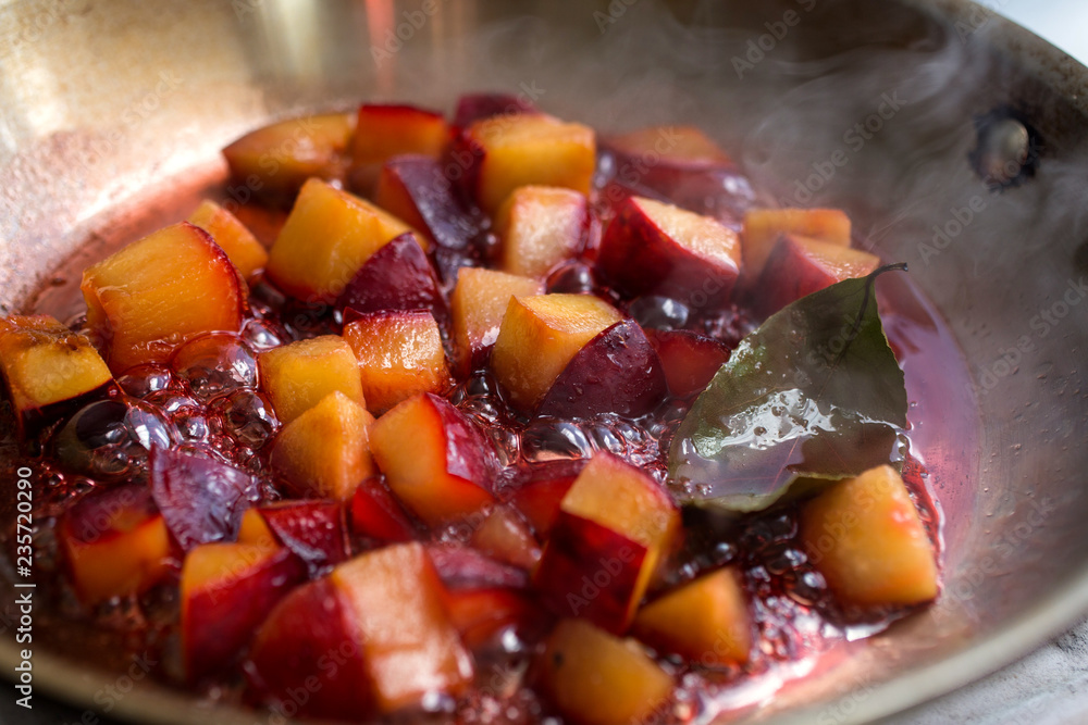 Close up of plum cooking in saucepan Close up of plum cooking in saucepan