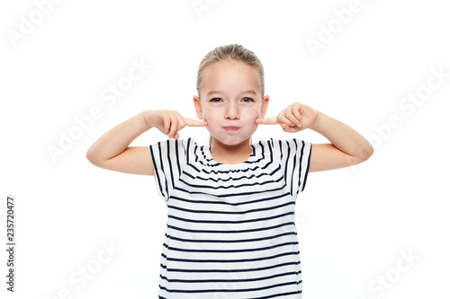 Cute young girl making special exercises at speech therapy office. Child speech therapy concept on white background. Speech impediment corrective exercises.