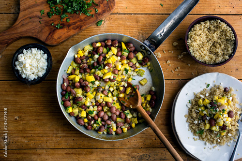 Overhead view of spicy brown bean, squash and corn succotash served in saucepan