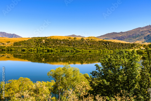 Peaceful and calm scene  relaxing hilly and lake landscape. Lake Hayes  Queenstown  New Zealand.