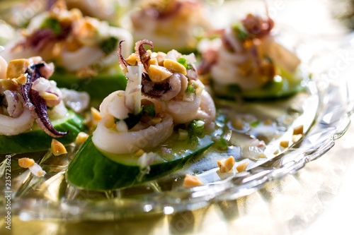 Close up of spicy thai squid with chilies and cilantro photo