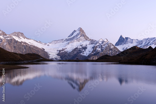 Picturesque view on Bachalpsee lake in Swiss Alps mountains. Snowy peaks of Wetterhorn  Mittelhorn and Rosenhorn on background. Grindelwald valley  Switzerland. Landscape photography