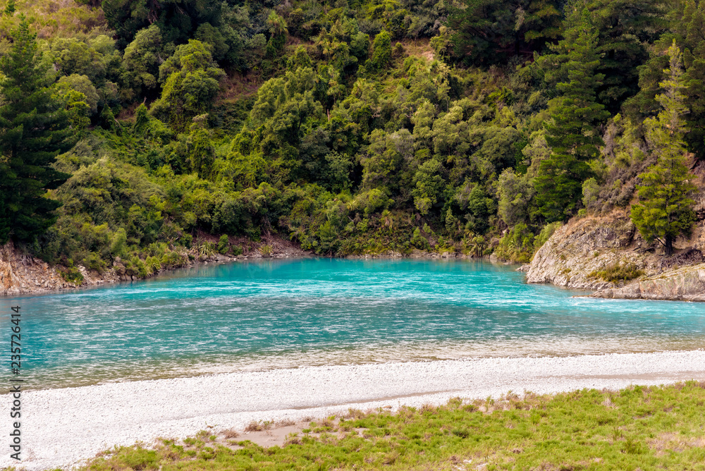 Crystal clear turquoise glacier fresh water flowing at the bend of Rakaia River at Rakaia Gorge Valley, Canterbury, New Zealand