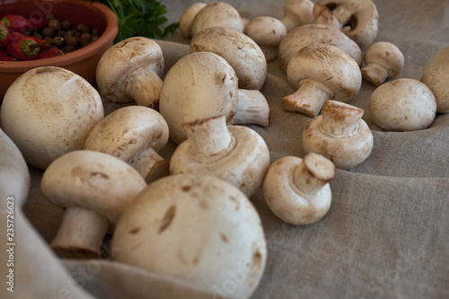 Champignon mushrooms on a gray cloth