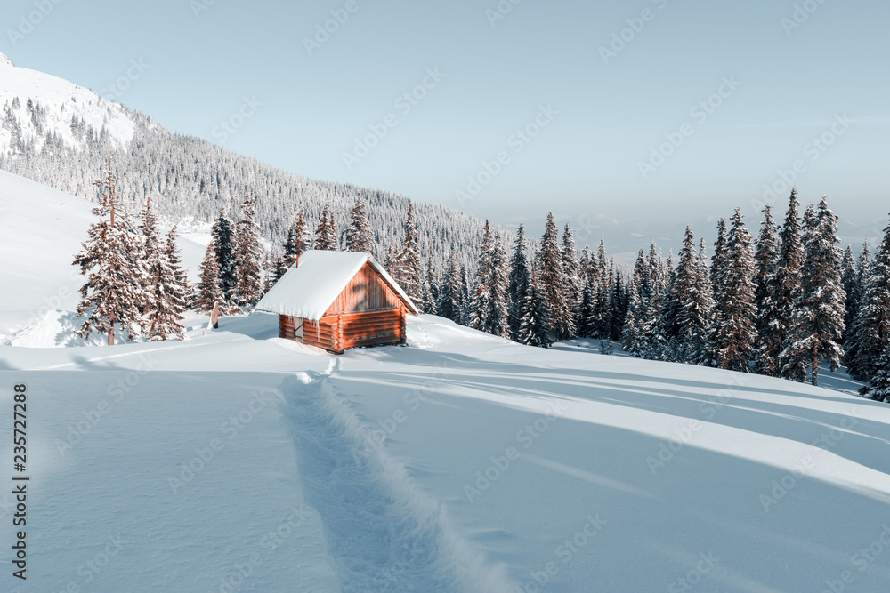 Fantastic winter landscape with wooden house in snowy mountains. Christmas holiday concept. Carpathians mountain, Ukraine, Europe Fantastic winter landscape with wooden house in snowy mountains. Christmas holiday concept. Carpathians mountain, Ukraine, Europe