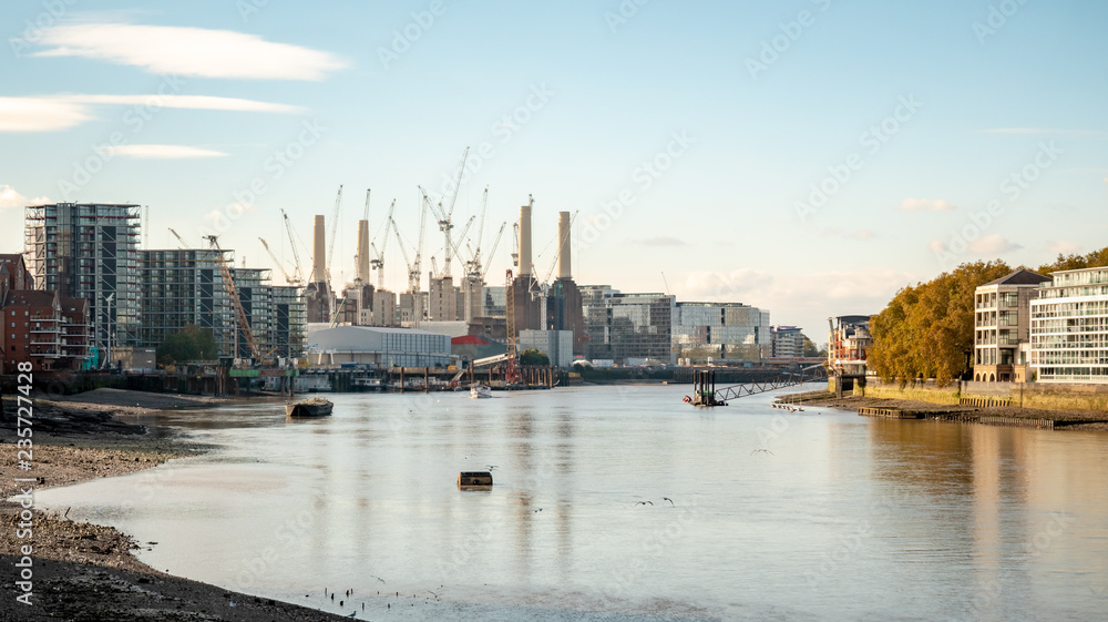 Battersea Power Station and the River Thames at low tide, West London. Building and construction work being carried out on the famous London landmark.