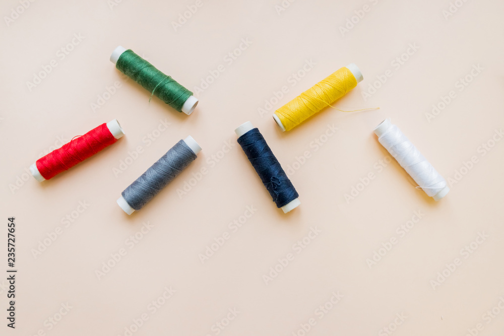 collection of various sewing threads on pastel background. each one is shot separately. knittinng tools.Natural cotton string roll isolated, copy space.Colored thread coils multi colored embroidery collection of various sewing threads on pastel background. each one is shot separately. knittinng tools.Natural cotton string roll isolated, copy space.Colored thread coils multi colored embroidery